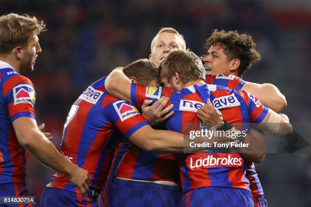 Dane Gagai of the Knights celebrates a try with team mates during the round 19 NRL match between the Newcastle Knights and the Brisbane Broncos at...