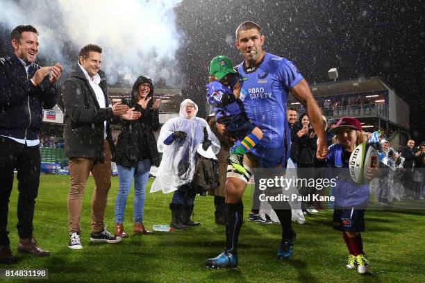 Matt Hodgson of the Force runs onto the field with his children Buddy and Hunter to play his final game during the round 17 Super Rugby match between...