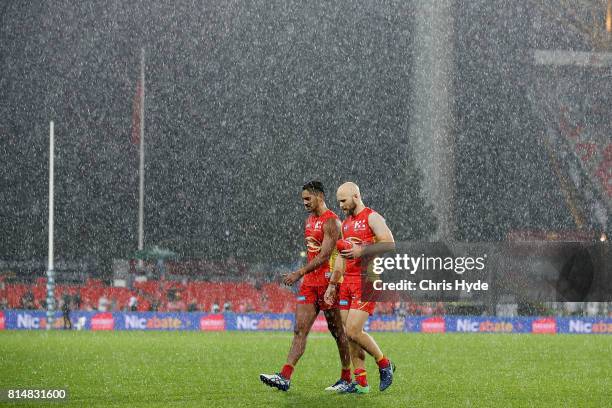 Aaron Hall and Gary Ablett of the Suns leave the field after losing the round 17 AFL match between the Gold Coast Suns and the Collingwood Magpies at...