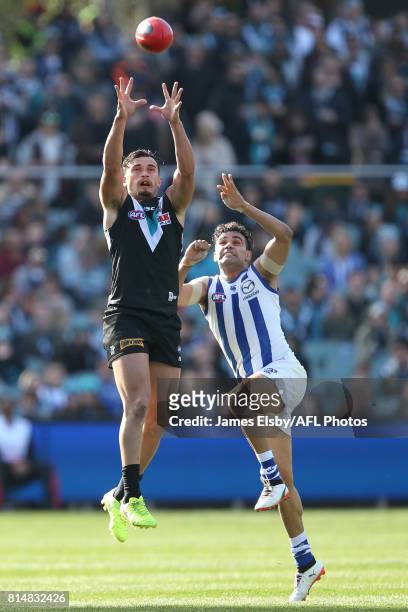 Sam Powell-Pepper of the Power flies with Lindsay Thomas of the Kangaroos during the 2017 AFL round 17 match between the Port Adelaide Power and the...