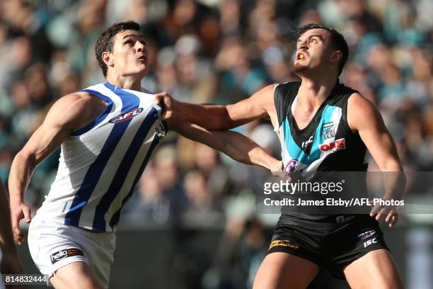 Scott Thompson of the Kangaroos competes with Sam Powell-Pepper of the Power during the 2017 AFL round 17 match between the Port Adelaide Power and...