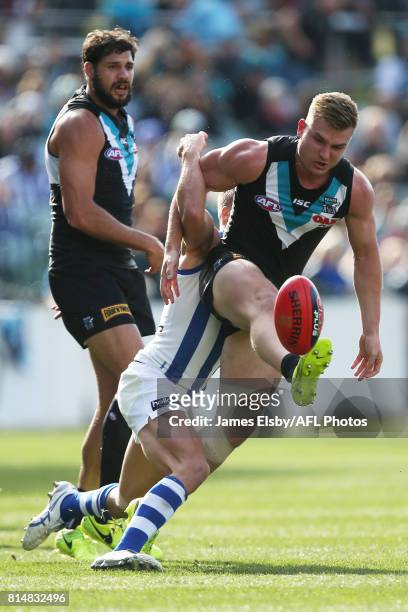 Andrew Swallow of the Kangaroos tackles Ollie Wines of the Power during the 2017 AFL round 17 match between the Port Adelaide Power and the North...