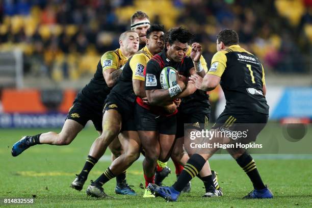 Seta Tamanivalu of the Crusaders is tackled by Julian Savea, TJ Perenara and Ben May of the Hurricanes during the round 17 Super Rugby match between...