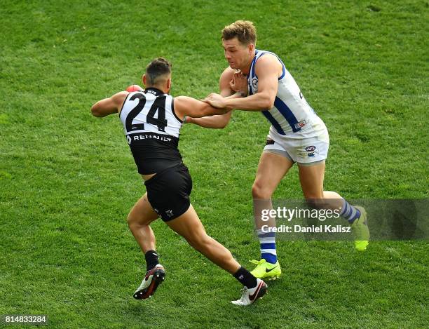 Shaun Higgins of the Kangaroos tackles Jarman Impey of the Power during the round 17 AFL match between the Port Adelaide Power and the North...