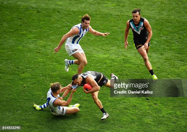 Shaun Higgins of the Kangaroos tackles Jarman Impey of the Power during the round 17 AFL match between the Port Adelaide Power and the North...