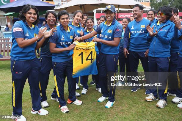 Inoka Ranaweera, Captain of Sri Lanka presents Shashikala Siriwardene with her one hundredth cap during the ICC Women's World Cup 2017 match between...