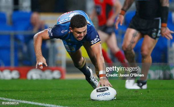 Ashley Taylor of the Titans scores a try during the round 19 NRL match between the Gold Coast Titans and the Cronulla Sharks at Cbus Super Stadium on...