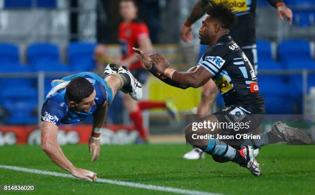 Ashley Taylor of the Titans scores a try during the round 19 NRL match between the Gold Coast Titans and the Cronulla Sharks at Cbus Super Stadium on...