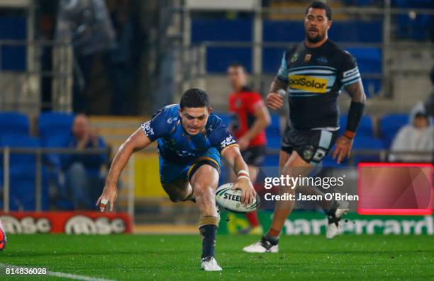 Ashley Taylor of the Titans scores a try during the round 19 NRL match between the Gold Coast Titans and the Cronulla Sharks at Cbus Super Stadium on...