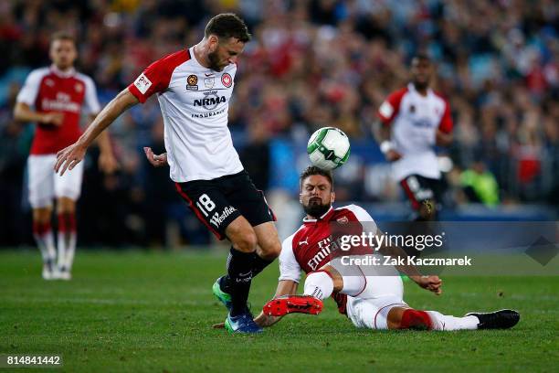 Robbie Cornthwaite of the Wanderers is tackled by Olivier Giroud of Arsenal during the match between the Western Sydney Wanderers and Arsenal FC at...