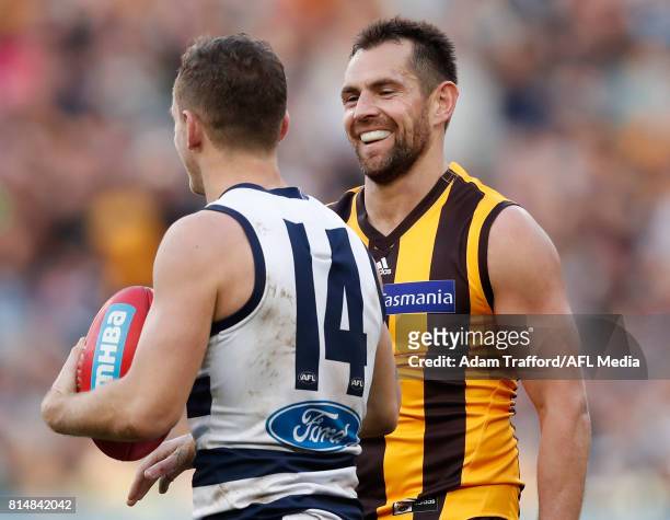 Luke Hodge of the Hawks playing his 300th game shares a laugh with Joel Selwood of the Cats after giving away a free kick to Selwood during the 2017...