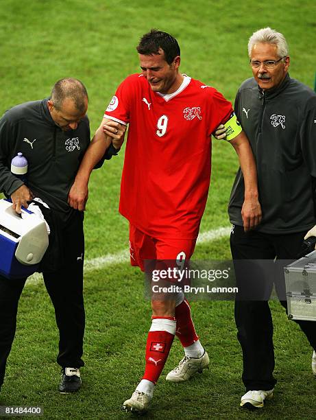 Alexander Frei of Switzerland is helped off the pitch during the Euro 2008 Group A match between Switzerland and Czech Republic at St. Jakob-Park on...