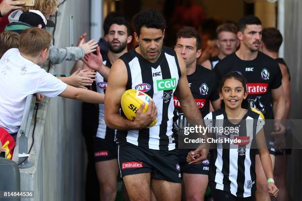 Daniel Wells of the Magpies walks out for his 250th match during the round 17 AFL match between the Gold Coast Suns and the Collingwood Magpies at...