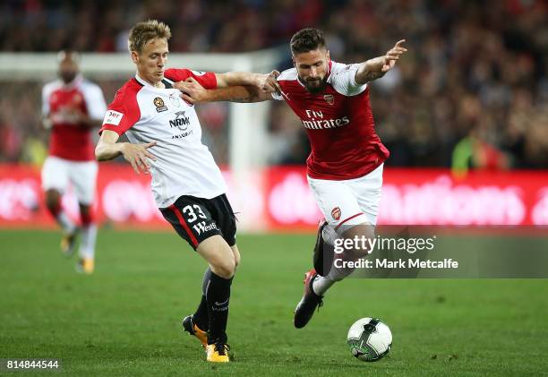 Olivier Giroud of Arsenal holds off Michael Thwaite of the Wanderers during the match between the Western Sydney Wanderers and Arsenal FC at ANZ...