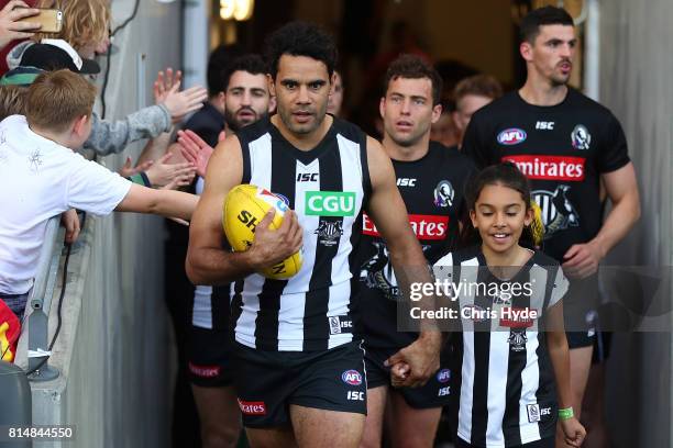 Daniel Wells of the Magpies walks out for his 250th match during the round 17 AFL match between the Gold Coast Suns and the Collingwood Magpies at...