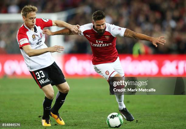 Olivier Giroud of Arsenal holds off Michael Thwaite of the Wanderers during the match between the Western Sydney Wanderers and Arsenal FC at ANZ...