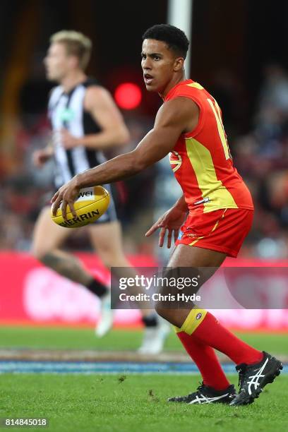 Touk Miller of the Suns kicks during the round 17 AFL match between the Gold Coast Suns and the Collingwood Magpies at Metricon Stadium on July 15,...