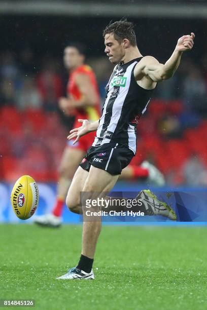 Josh Thomas of the Magpies kicks during the round 17 AFL match between the Gold Coast Suns and the Collingwood Magpies at Metricon Stadium on July...