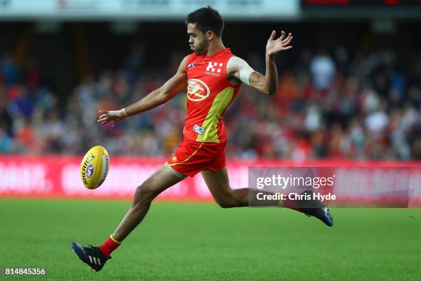 Jack Martin of the Suns kicks during the round 17 AFL match between the Gold Coast Suns and the Collingwood Magpies at Metricon Stadium on July 15,...