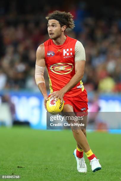 Jarrod Harbrow of the Suns kicks during the round 17 AFL match between the Gold Coast Suns and the Collingwood Magpies at Metricon Stadium on July...