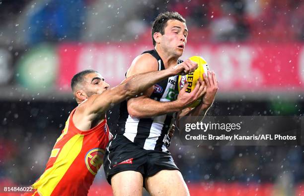 Jarryd Blair of the Collingwood Magpies takes a mark during the round 17 AFL match between the Gold Coast Suns and the Collingwood Magpies at...