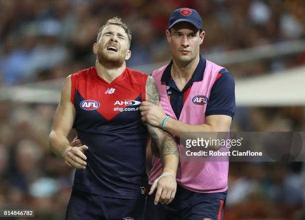 Dean Kent of the Demons leaves the field with an injury during the round 17 AFL match between the Melbourne Demons and the Adelaide Crows at TIO...