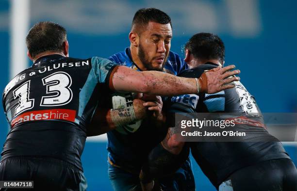 Leivaha Pulu of the titans runs with the ball during the round 19 NRL match between the Gold Coast Titans and the Cronulla Sharks at Cbus Super...