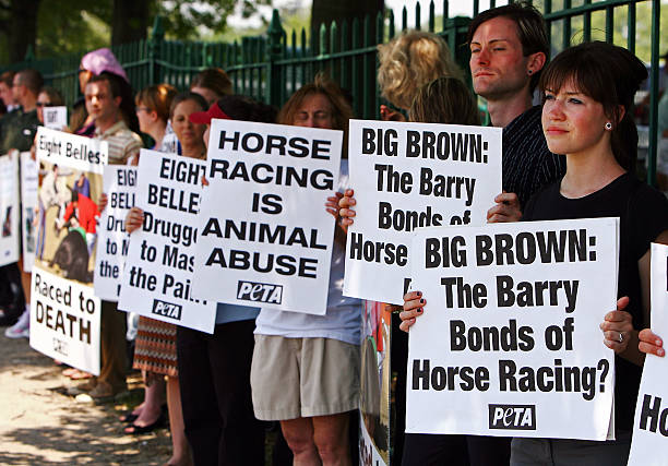 Demonstrators protest outside the entrance of Belmont Park before the 140th running of the Belmont Stakes on June 7, 2008 in Elmont, New York. The...