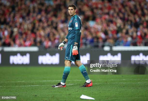 Arsenal goalkeeper Emiliano Martinez looks at a paper plane that was thrown onto the pitch during the match between the Western Sydney Wanderers and...