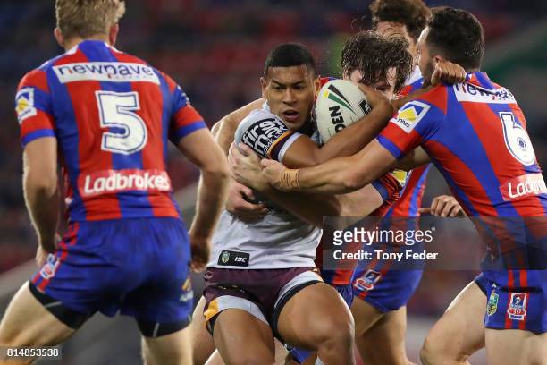 Jamayne Isaako of the Broncos is tackled during the round 19 NRL match between the Newcastle Knights and the Brisbane Broncos at McDonald Jones...