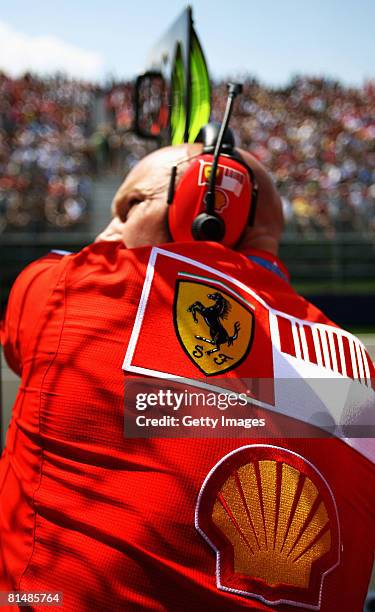 Ferrari mechanic holds out his teams pit board during qualifying for the Canadian Formula One Grand Prix at the Circuit Gilles Villeneuve June 7,...