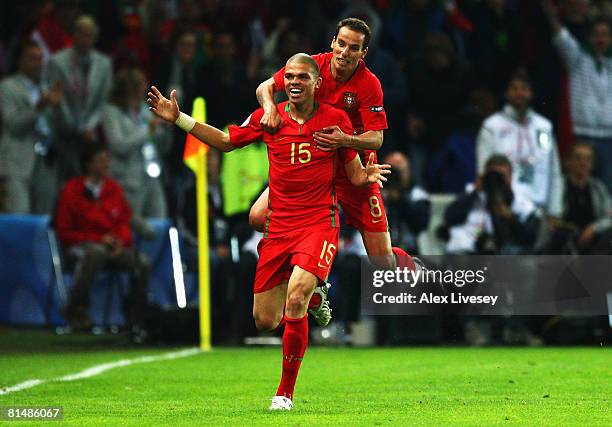 Pepe of Portugal is celebrated by his team mate Petit of Portugal after scoring the first goal while Hamit Altintop of Turkey can just watch on...