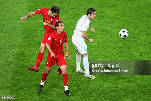 Ricardo Carvalho and Petit of Portugal jump for a header with Nihat Kahveci of Turkey during the UEFA EURO 2008 Group A match between Portugal and...