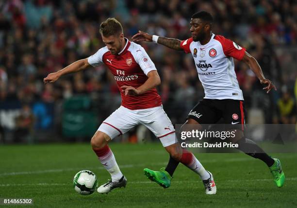 Aaron Ramsey of Arsenal takes on Roly Bonevacia of Western Wanderers during the match between the Western Sydney Wanderers and Arsenal FC at ANZ...