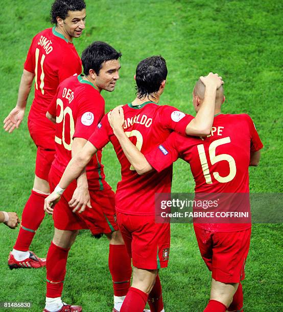 Portuguese forward Simao Sabros, Portuguese midfielder Deco and Portuguese forward Cristiano Ronaldo congratulate teammate Pepe after he scored the...