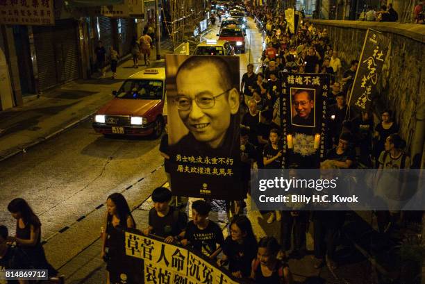 Protesters carrying candles take part in a march to mourn the death of Nobel laureate Liu Xiaobo on July 15, 2017 in Hong Kong, Hong Kong. The body...