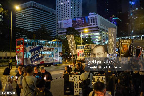 Protesters carrying candles take part in a march to mourn the death of Nobel laureate Liu Xiaobo on July 15, 2017 in Hong Kong, Hong Kong. The body...