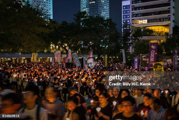 Protesters carrying candles take part in a march to mourn the death of Nobel laureate Liu Xiaobo on July 15, 2017 in Hong Kong, Hong Kong.The body of...