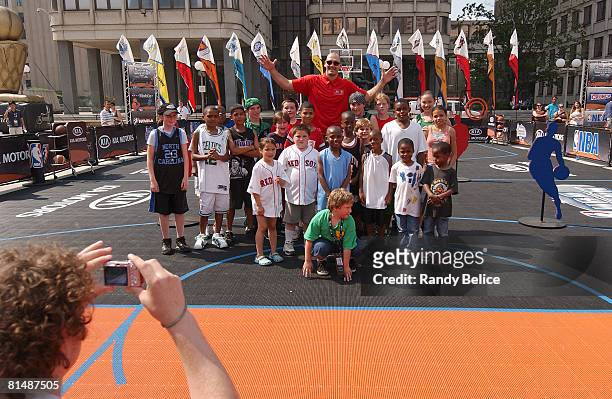 Scot Pollard of the Boston Celtics poses for a group photo with contestants of a relay competition as part of an appearance at the NBA Nation Tour...