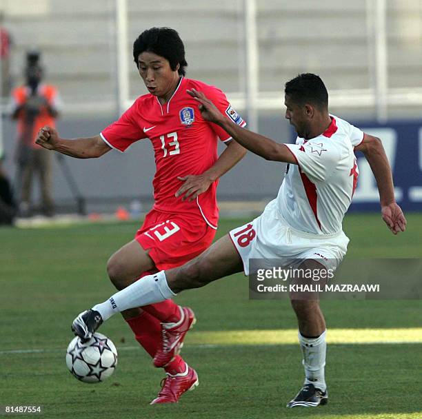 Jordan's Hasan Mahmud vies with Korean Lee Keun Ho during their 2010 World Cup qualifying football match in Amman on June 7, 2008. Korea won the...