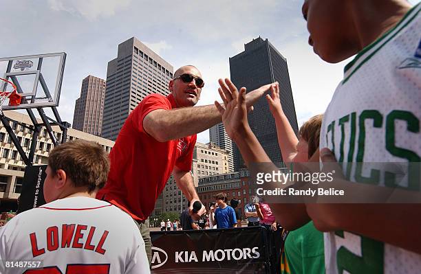 Scot Pollard of the Boston Celtics high fives his team during a relay competition as part of an appearance at the NBA Nation Tour stop at Boston City...