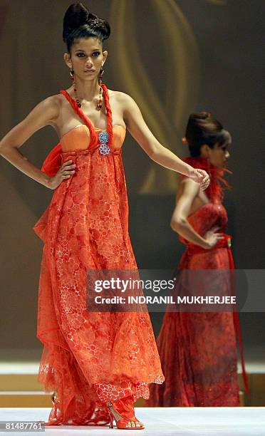 Models present creations from Thai design house Alta Moda at a fashion show on the second day of the International Indian Film Academy Awards 2008...