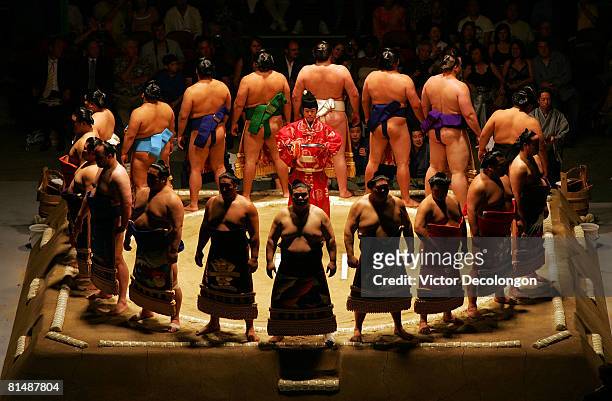 The East team stand in the dohyo after being introduced to the audience during the doyo-iri or "entering of the ring" ceremony of the 2008 Grand Sumo...
