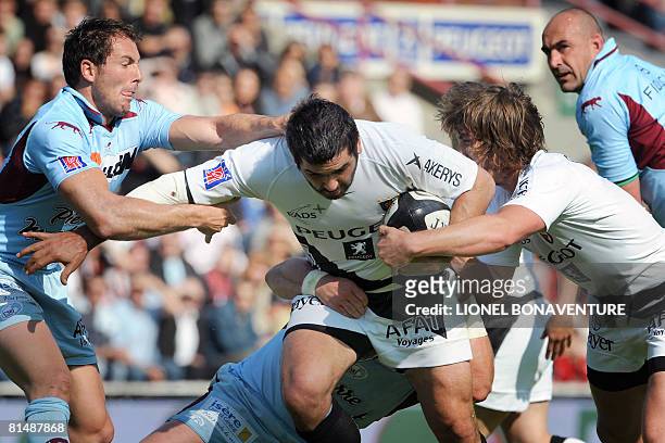 Toulouse's prop Alberto Basualdo and full-back Maxime Medard vies with Bourgoin's scrum-half Mickael Forest while flanker Chris Wyatt looks on during...