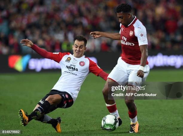 Arsenal's player Alex Iwobi fights for the ball with Steve Lustica of the Western Sydney Wanderers during their pre-season football friendly played...