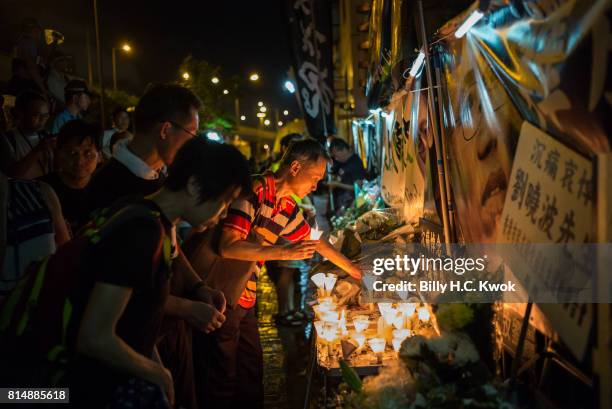 Protesters carrying candles take part in a march to mourn the death of Nobel laureate Liu Xiaobo on July 15, 2017 in Hong Kong, Hong Kong. The body...