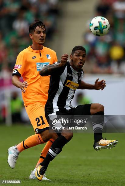 Benjamin Huebner challenges Kwame Yeboah of Moenchengladbach during the Telekom Cup 2017 3rd place match between Borussia Moenchengladbach and TSG...