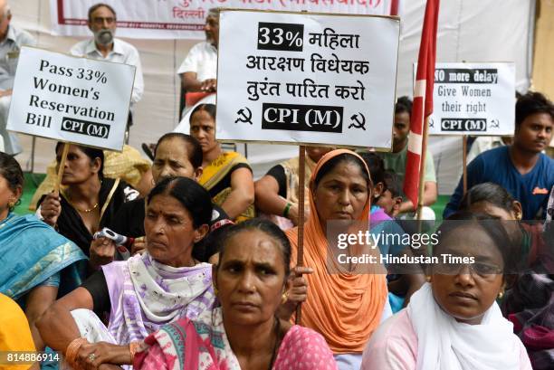 Communist Party of India members organise a dharna demanding passage of 33% Women's Reservation Bill in the monsoon session of the Parliament at...