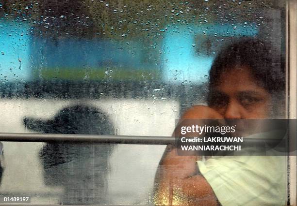 Sri Lankan woman sits inside a bus in Maharagama suburb of Colombo on June 7, 2008. Sri Lankans are living on the edge as a wave of bomb attacks,...