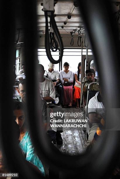 Sri Lankan passengers wait for departure inside a bus in Maharagama suburb of Colombo on June 7, 2008. Sri Lankans are living on the edge as a wave...
